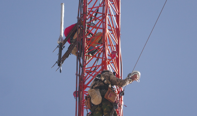 Gary Shatto and a fellow tower climber working on the Local News 8 backyard antenna tower